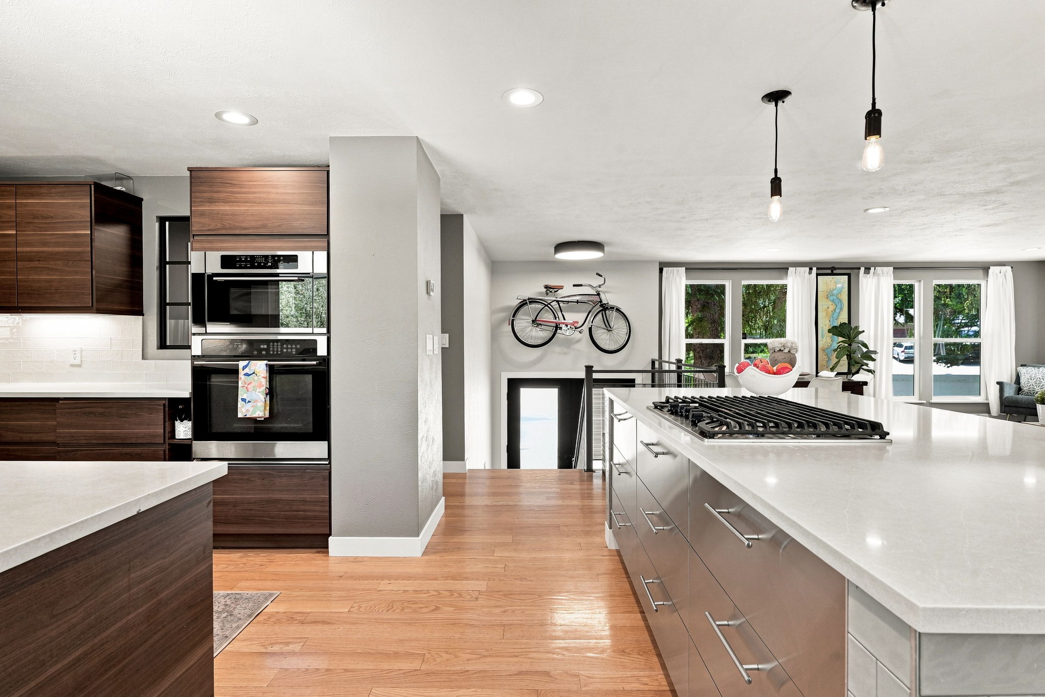 Gas cooktop, double wall ovens and an uninterrupted run of quartz.