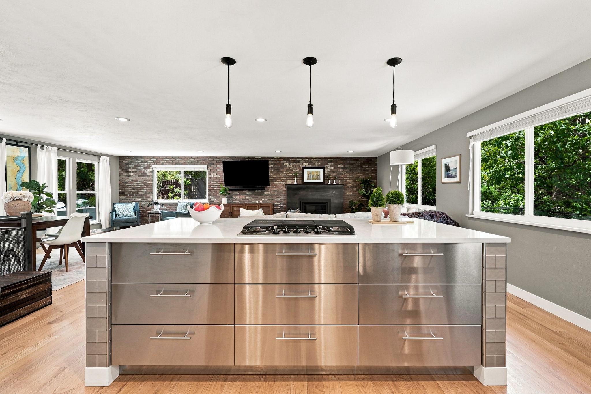 Stainless island opens directly to the living room and fireplace.