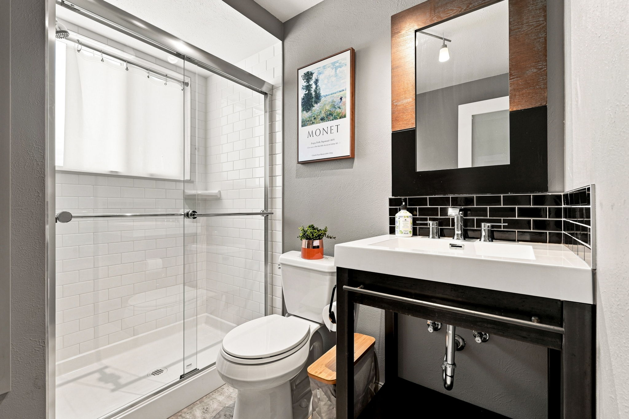 Third full bath on the lower level with a subway-tiled shower.