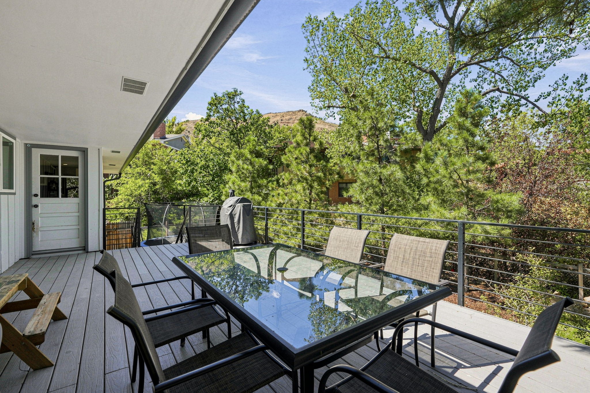 Covered deck looking out to the rock outcroppings above the neighborhood.