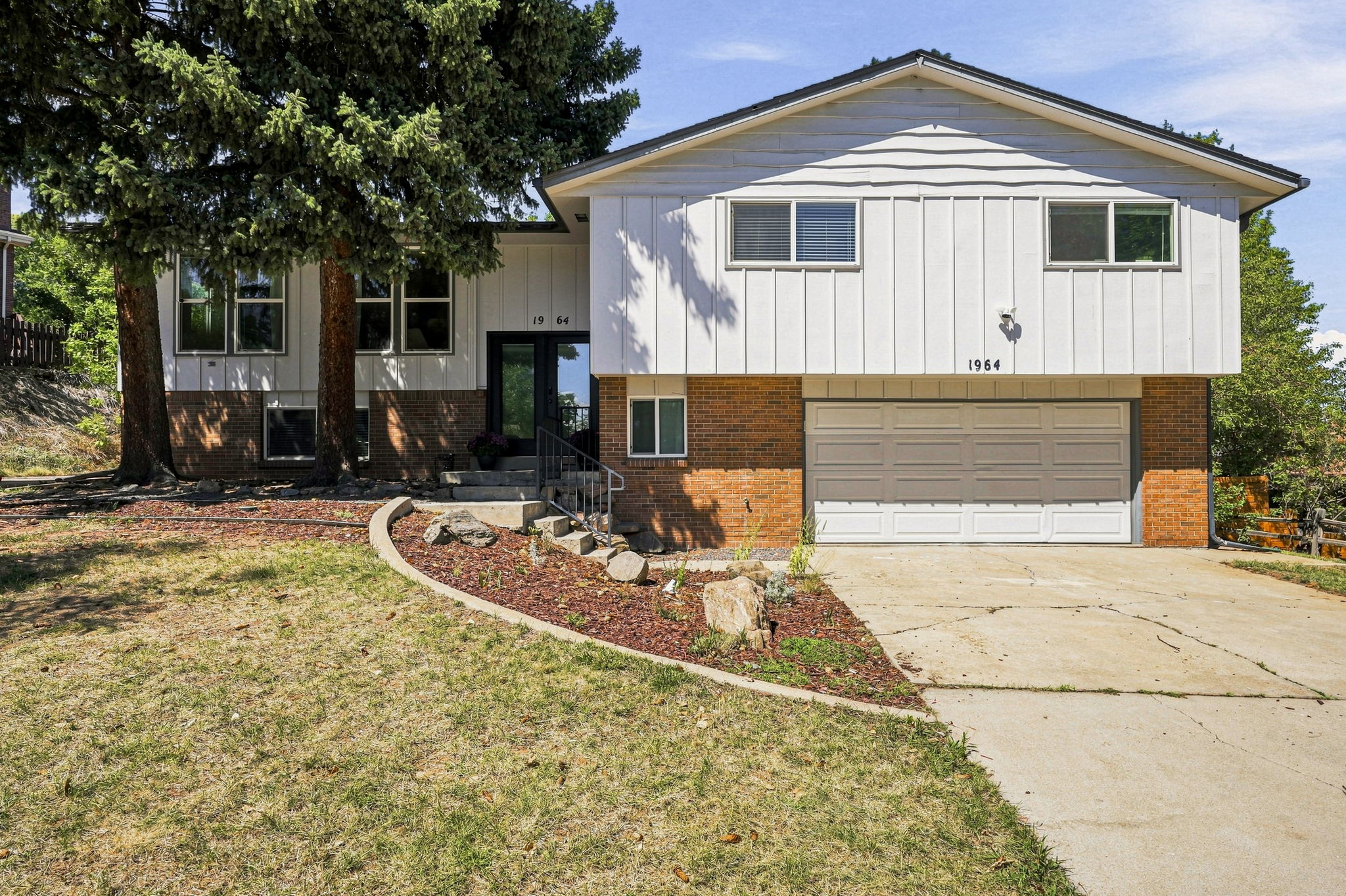 Board-and-batten and brick exterior with an oversized two-car garage.