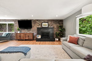 Living room anchored by a fireplace converted to gas for everyday use.