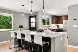 Large center island with cooktop and seating for four.