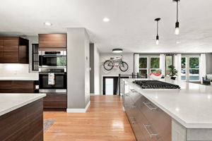 Gas cooktop, double wall ovens and an uninterrupted run of quartz.