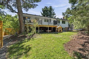 Extensively landscaped backyard beneath the elevated deck.