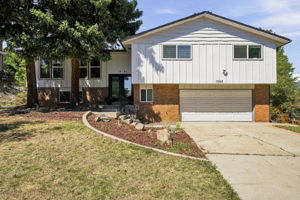 Board-and-batten and brick exterior with an oversized two-car garage.