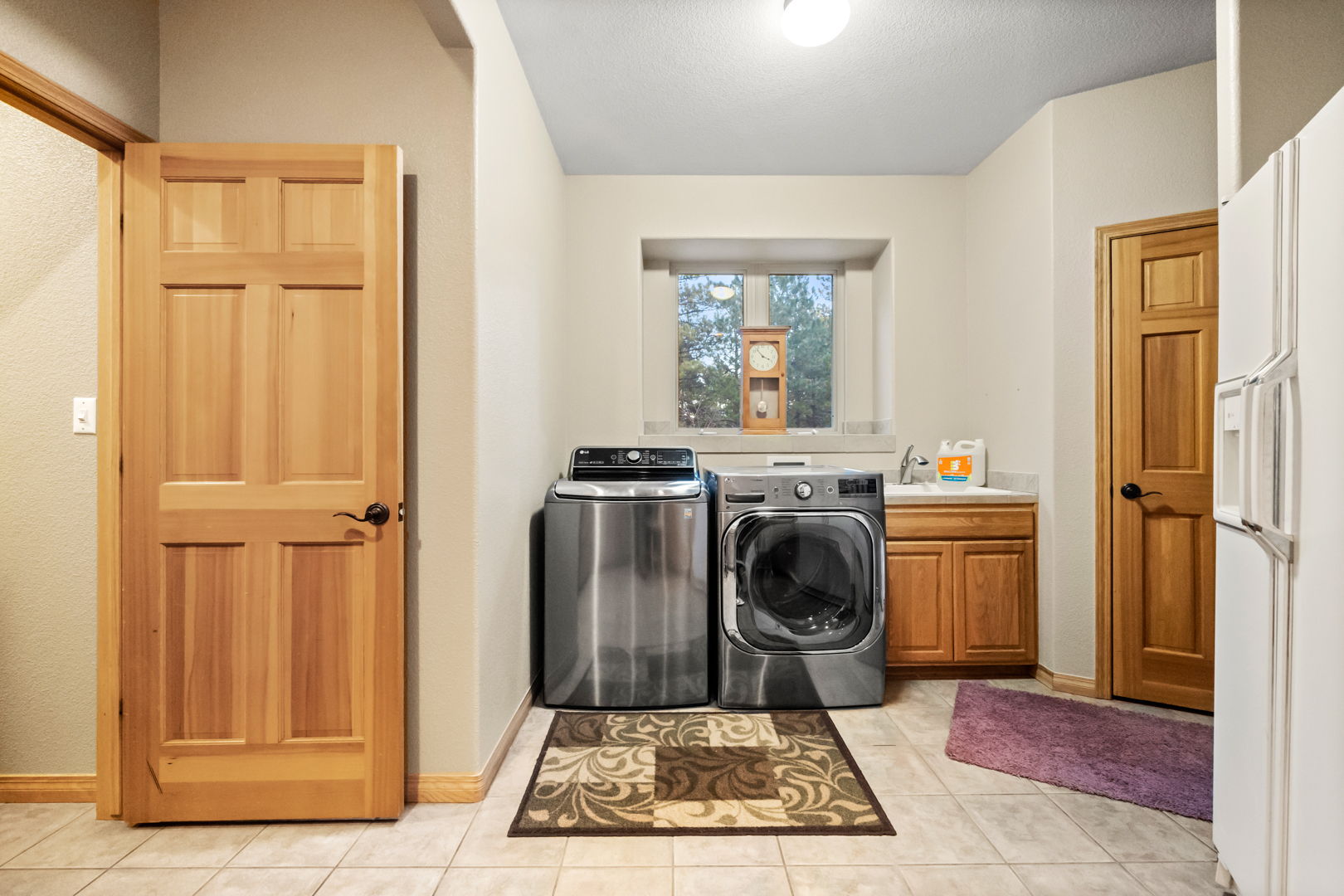Huge mud room/laundry with fridge and cabinetry