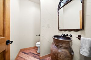 Powder bath with custom barrel sink in basement