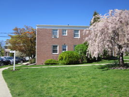 East-facing facade. 2 corner Bedrooms overlook courtyard entryway
