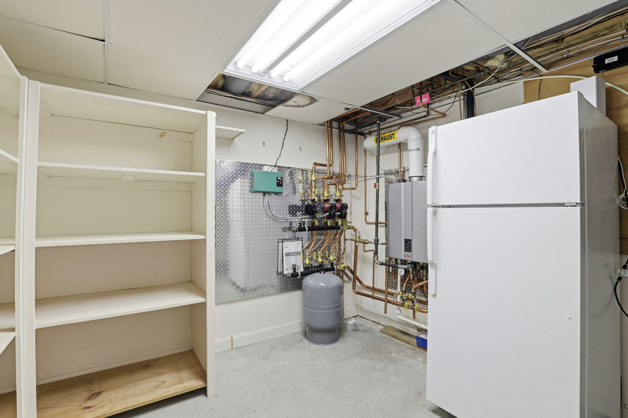 Utility Room | With fridge, storage and on-demand hot water heater