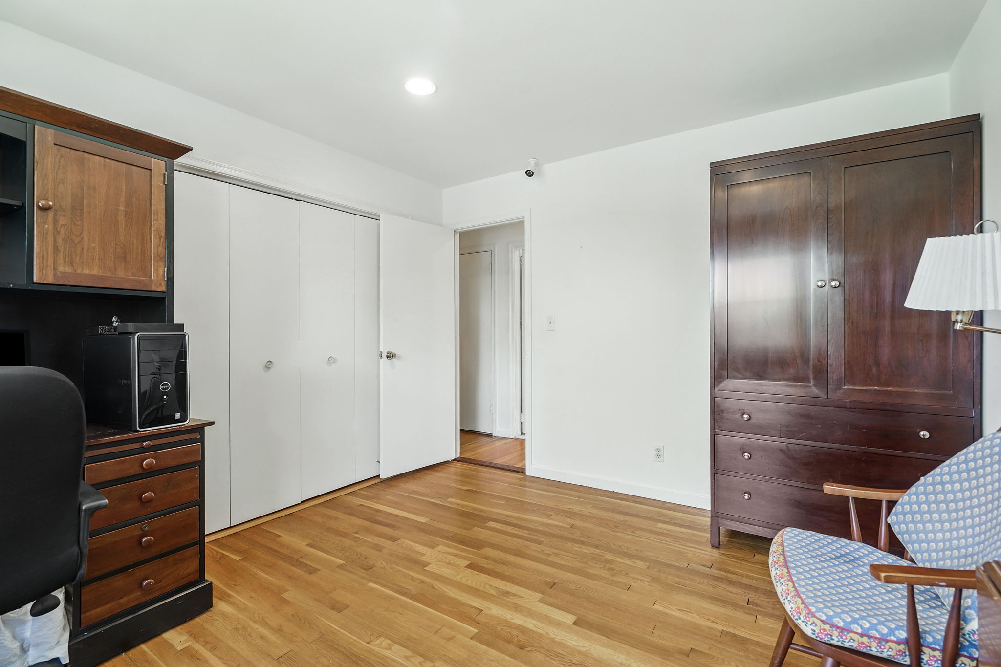 Bedroom with hardwood flooring and double closet