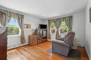 Bedroom with abundant window/natural lighting, hardwood floors and recessed lighting