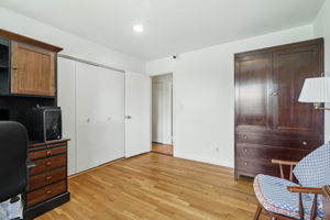 Bedroom with hardwood flooring and double closet