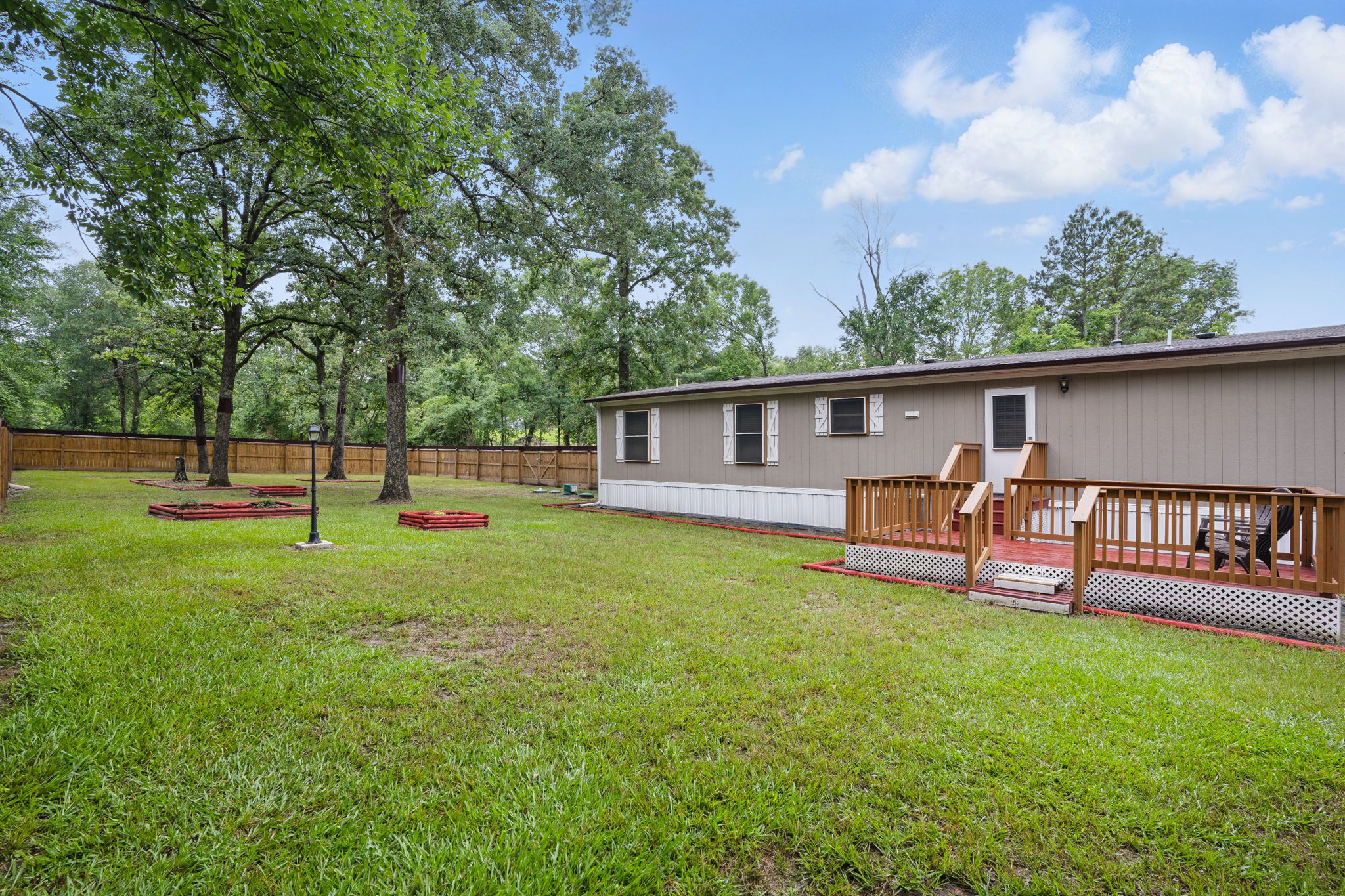 Expansive backyard with plenty of room for outdoor activities, gardening, or simply enjoying nature’s beauty.