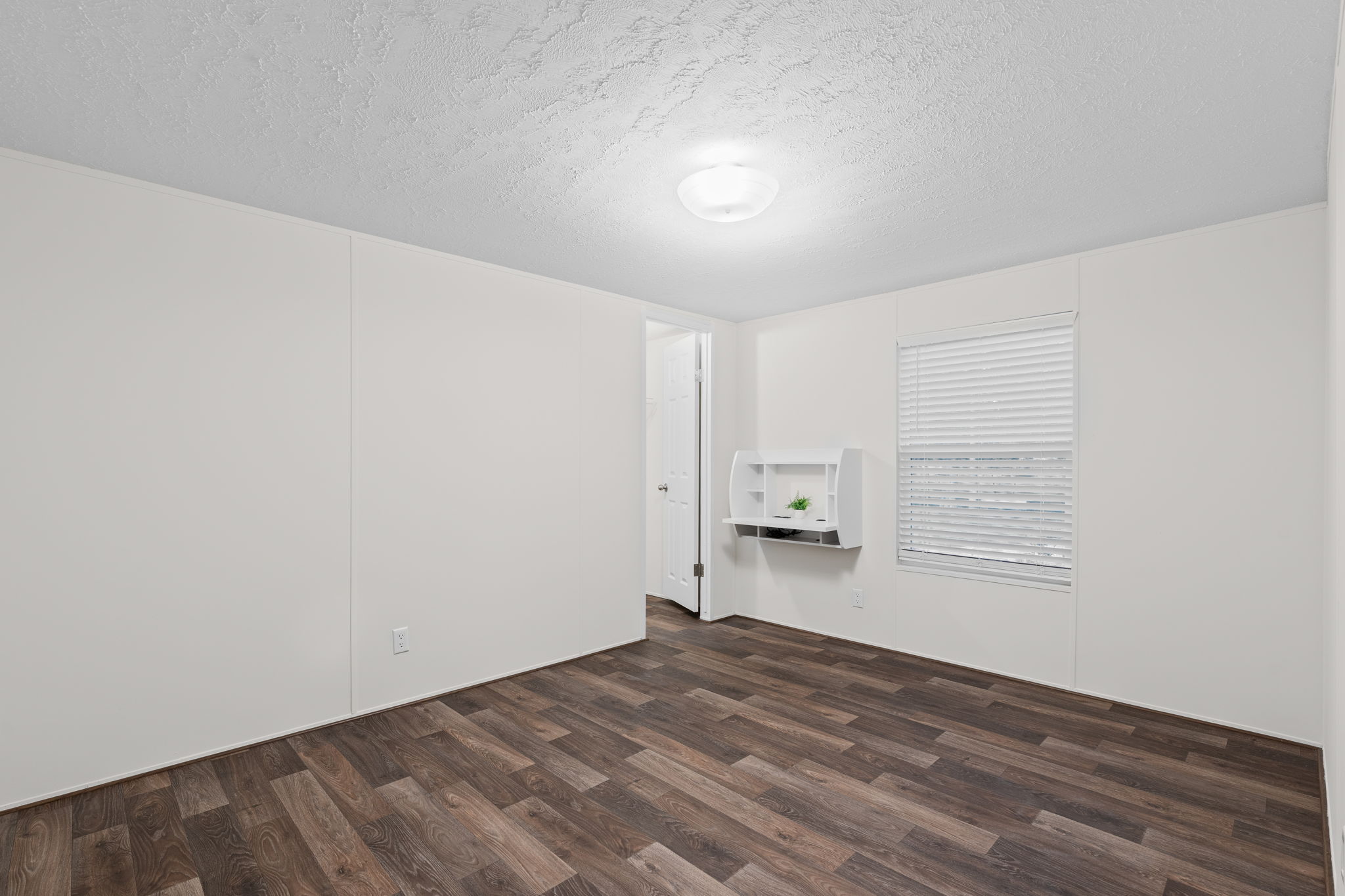 Comfortable and straightforward—this bedroom offers just the right amount of space and a built-in closet for easy storage.