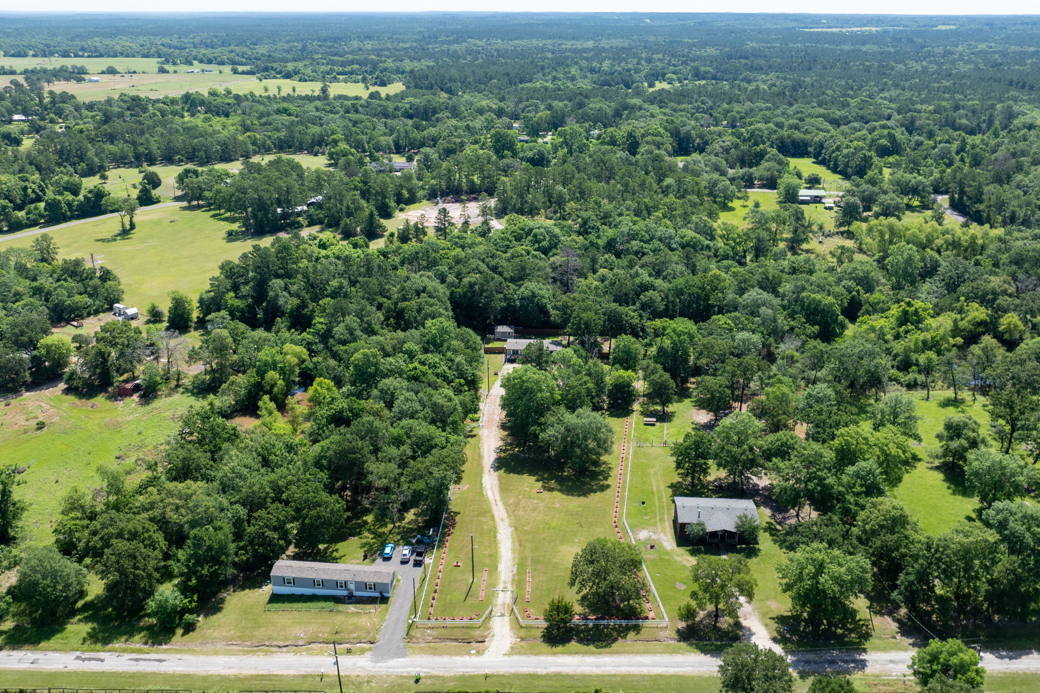 Aerial view showcasing the beautiful lot with gorgeous fencing—combining privacy, charm, and plenty of space to enjoy.