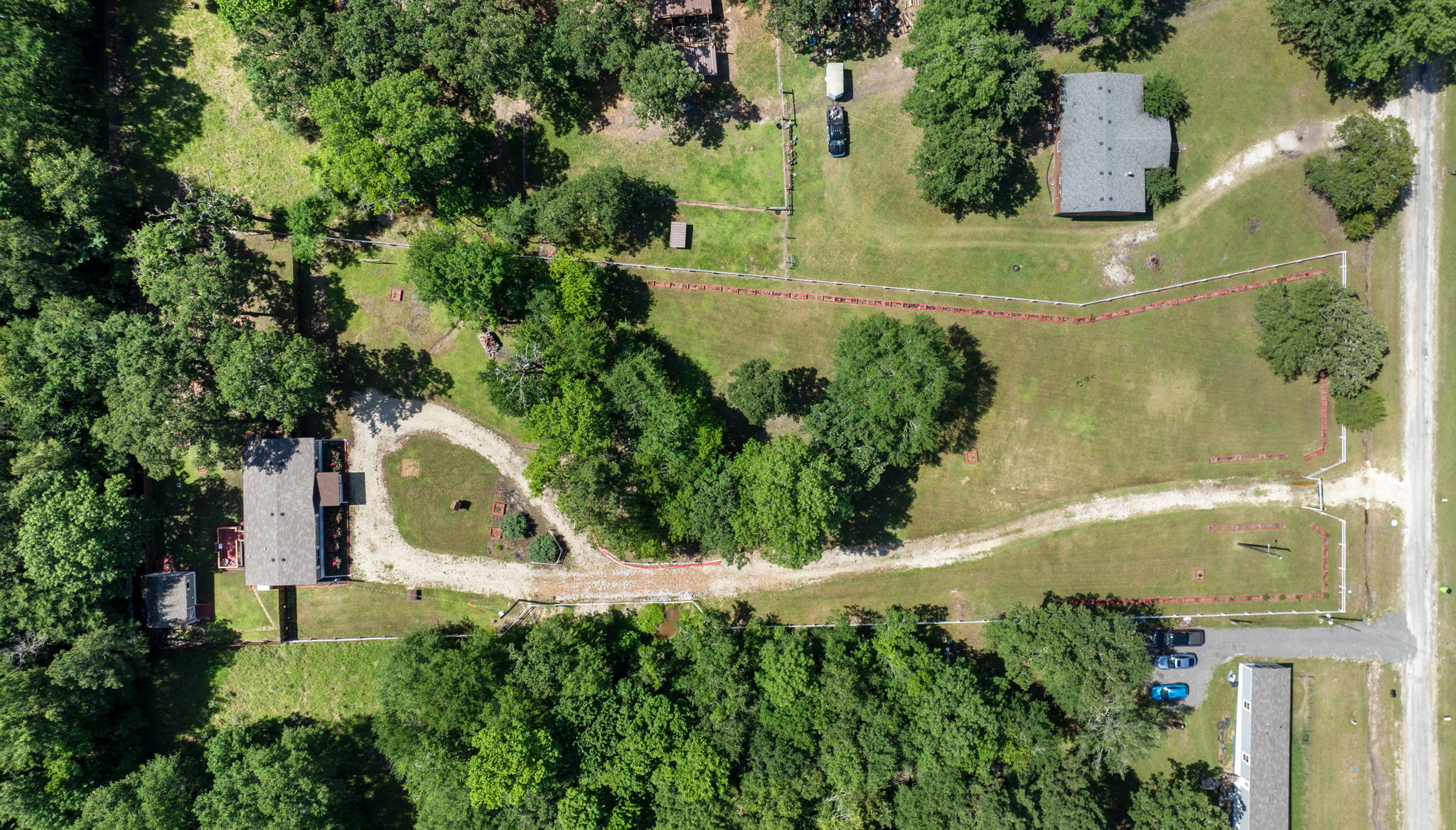 Bird’s-eye view capturing the entire lot and home—showcasing spacious grounds and the perfect setting for peaceful living.