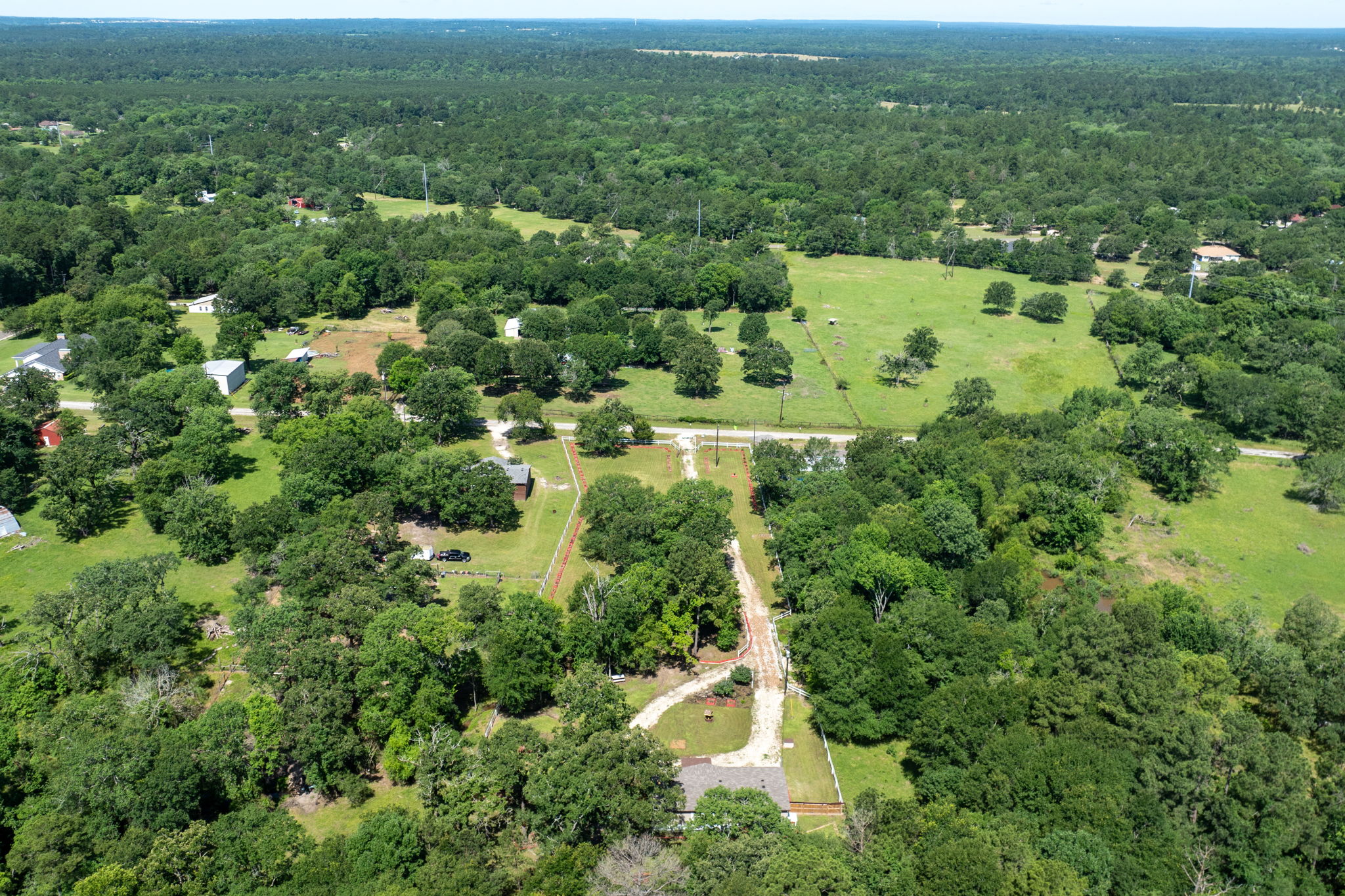 Peaceful rear view of the lot, featuring lush greenery and plenty of open space to make your own.