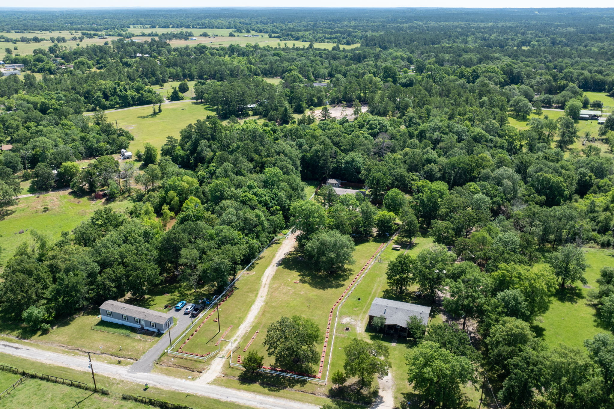 Front of the home facing left, perfectly positioned on a spacious, beautifully fenced lot.