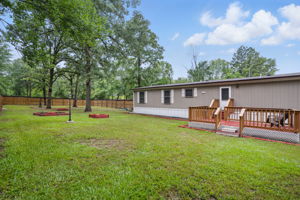 Expansive backyard with plenty of room for outdoor activities, gardening, or simply enjoying nature’s beauty.