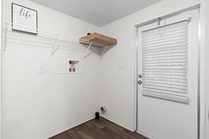 Dedicated laundry room with direct access to the backyard—practical and perfect for everyday living.