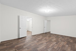 "Another view of the master bedroom, featuring easy access to the private bathroom for your convenience.