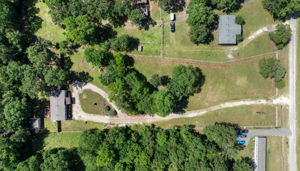 Bird’s-eye view capturing the entire lot and home—showcasing spacious grounds and the perfect setting for peaceful living.