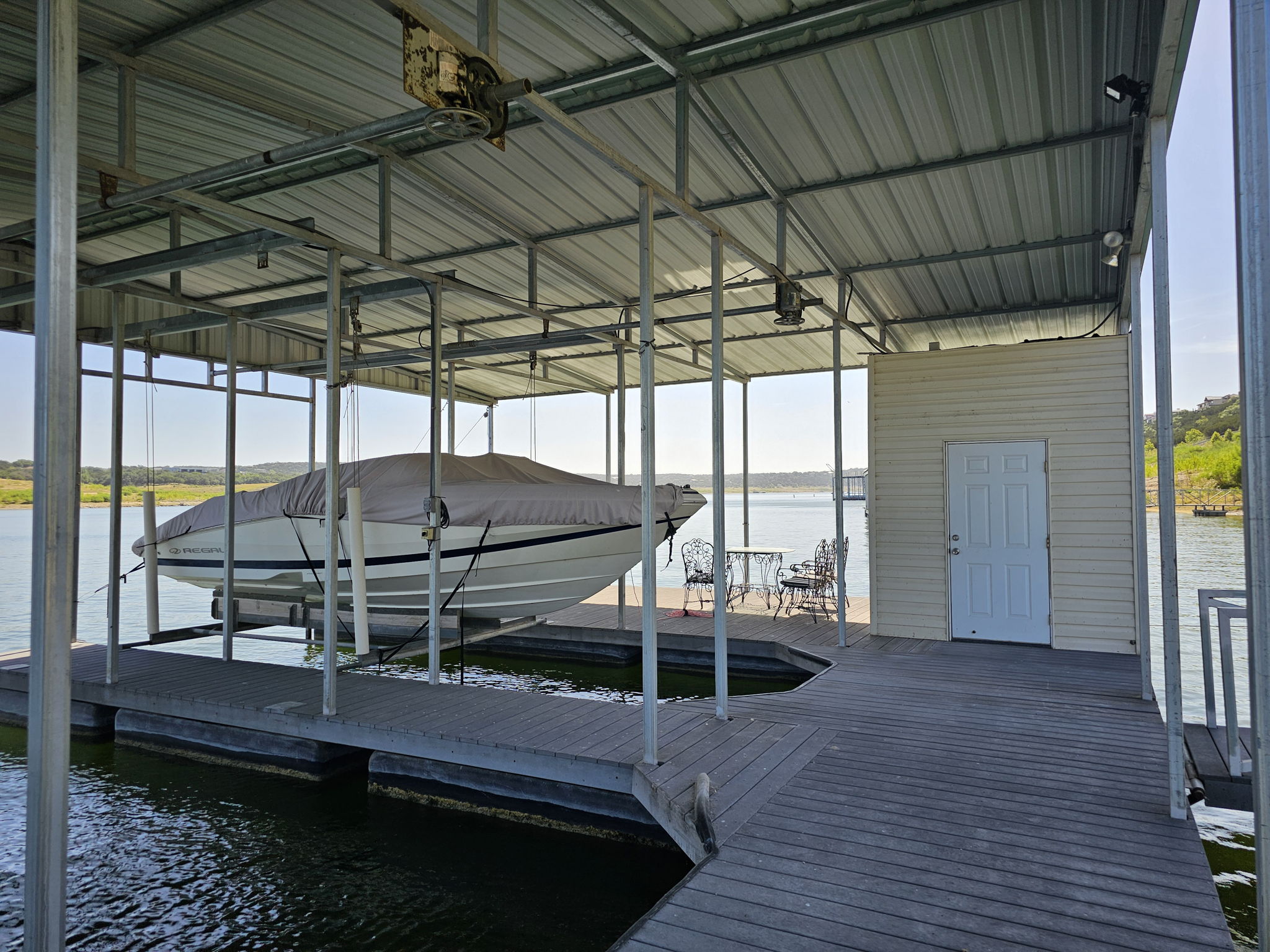 Your Private Boat Dock with 2 Slips, Rail System, Electric Hoist, Storage Area and Chairs in place for relaxing by the water.