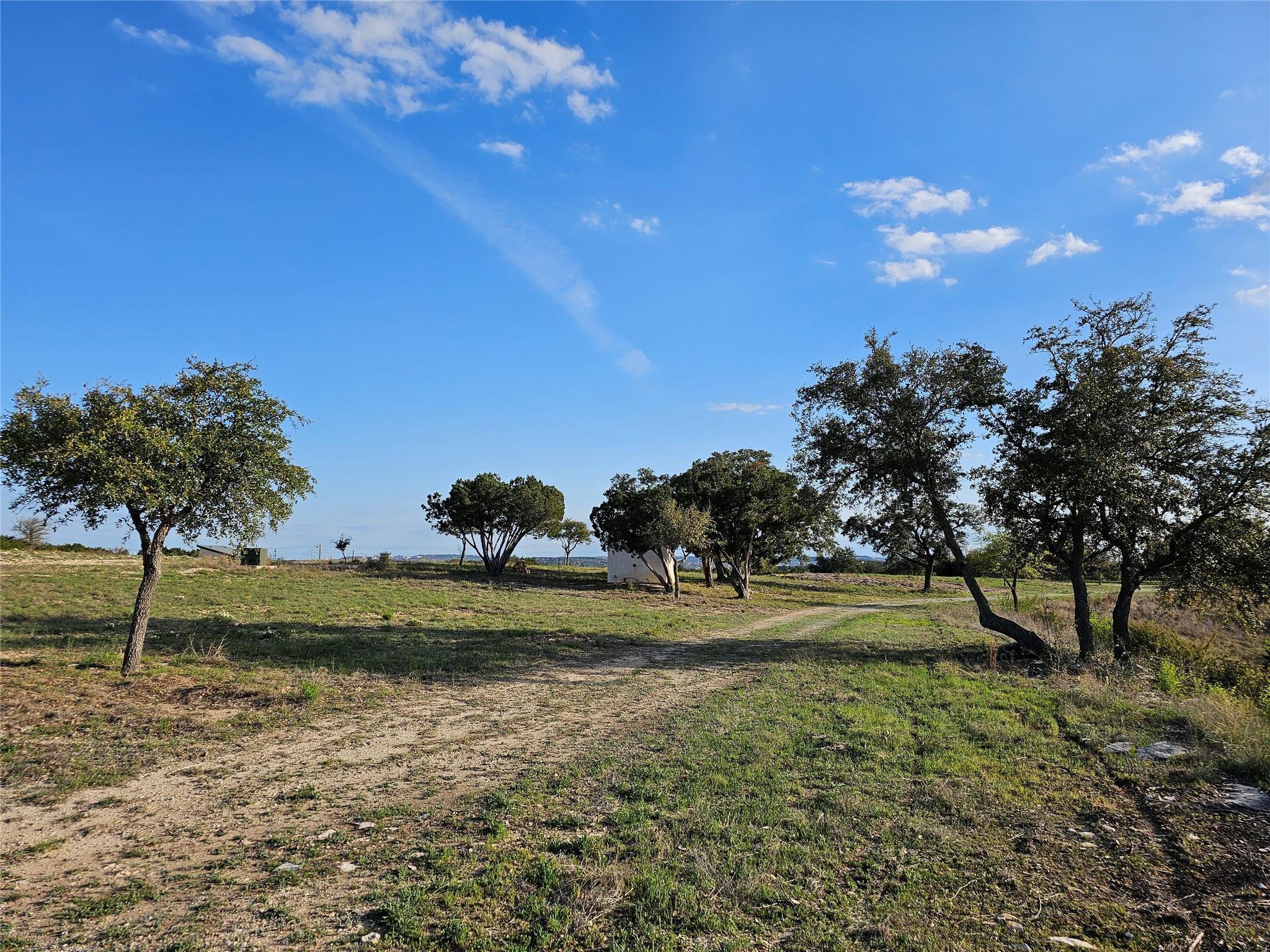 On the southwest side, the small well house is on the left.  You have some great views here too.