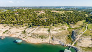 Lot 7 has the Blue Roof with a rail system.  Lot 8 has the rail system in place for a future boat dock. See the hilltop partly cleared for your new home.