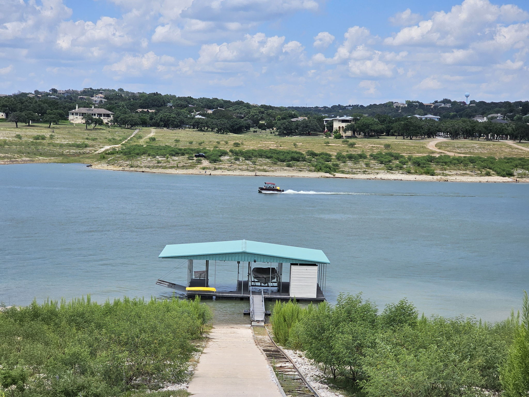 Easy Access to Your Private Boat Dock. The boat dock has 2 slips, jet ski cable lift, 1 swim ladder and storage. The top of the rail system is at about 700 ft elevation. The boat is not included. System allows boat dock to move with various water levels. Photo taken in June.
