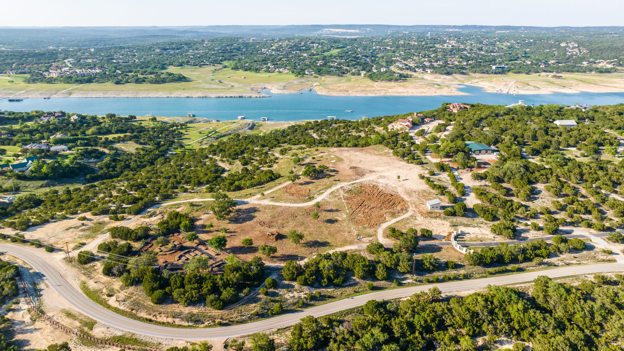Aerial view looking towards Lago Vista across the lake. The open land area is part of the 23.85 acres. Beautiful setting for a new homesite!