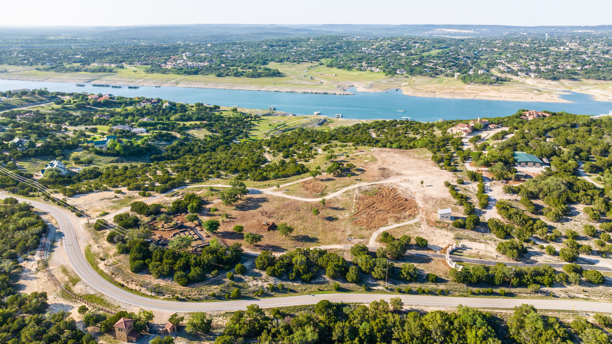Aerial View shows this large acreage property with the hilltop partially cleared. Easy access to your waterfront and dock.