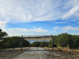 High Game Fence surrounds the Majority of the Property. This is the gate that leads down to the boat dock. This is out of the flood plain.