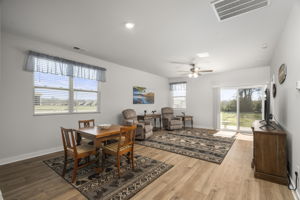 Open floorplan leads to covered rear patio.