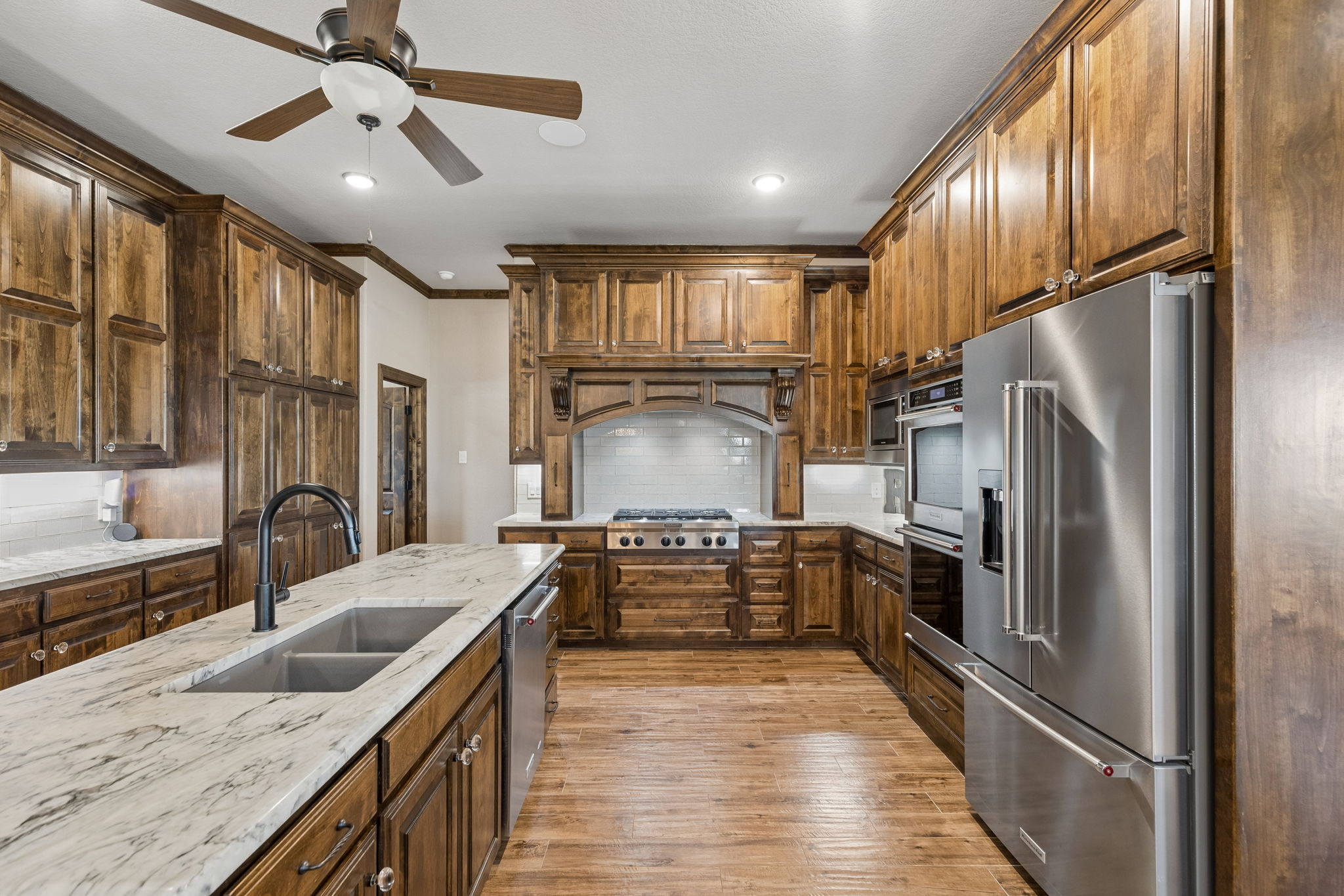 Oversized gas cooktop and abundant custom cabinetry for the cook's convenience and efficiency.