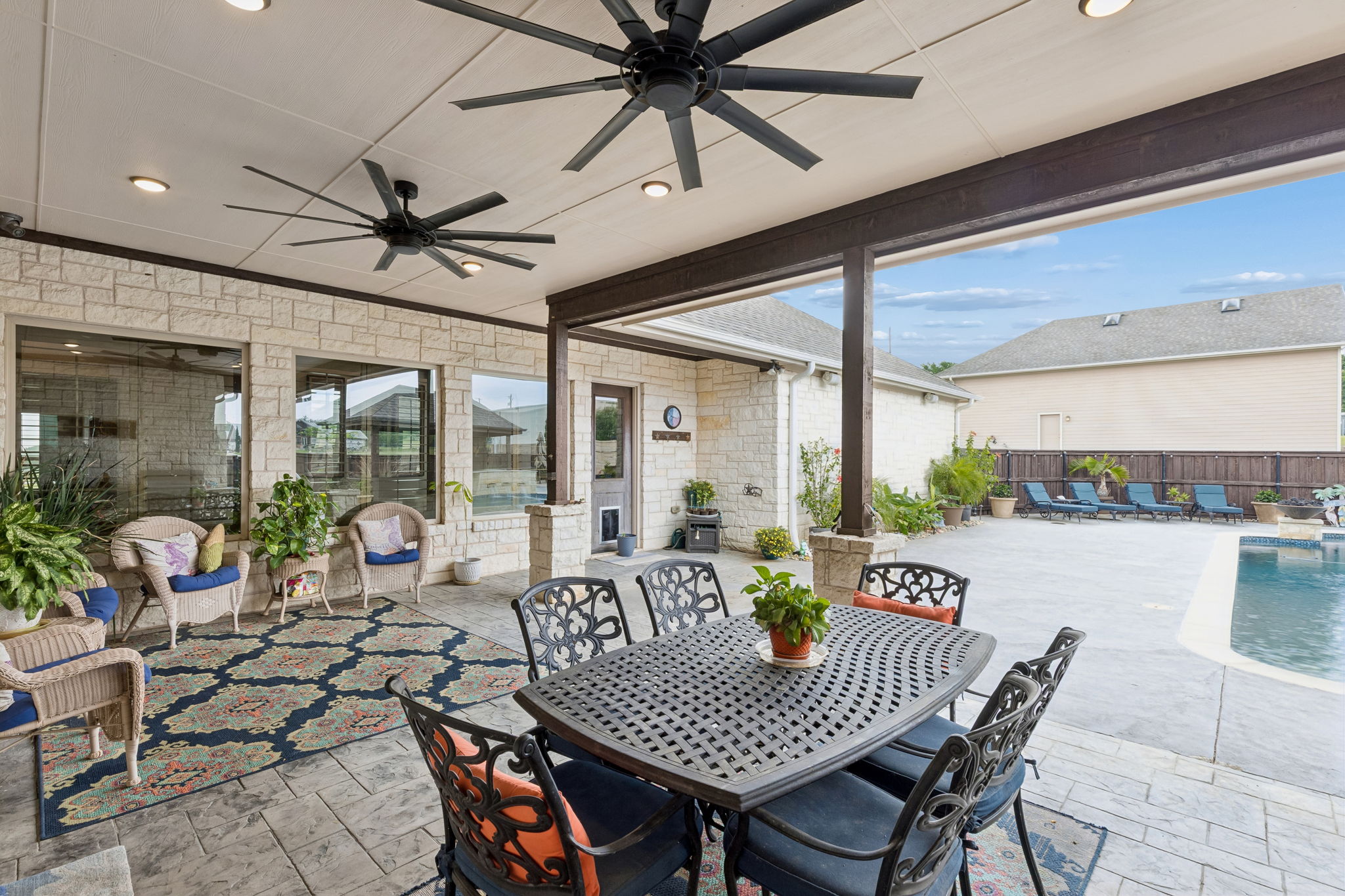 Dining or relaxing space in the shade and a door leading to a half bath for your guest's convenience.
