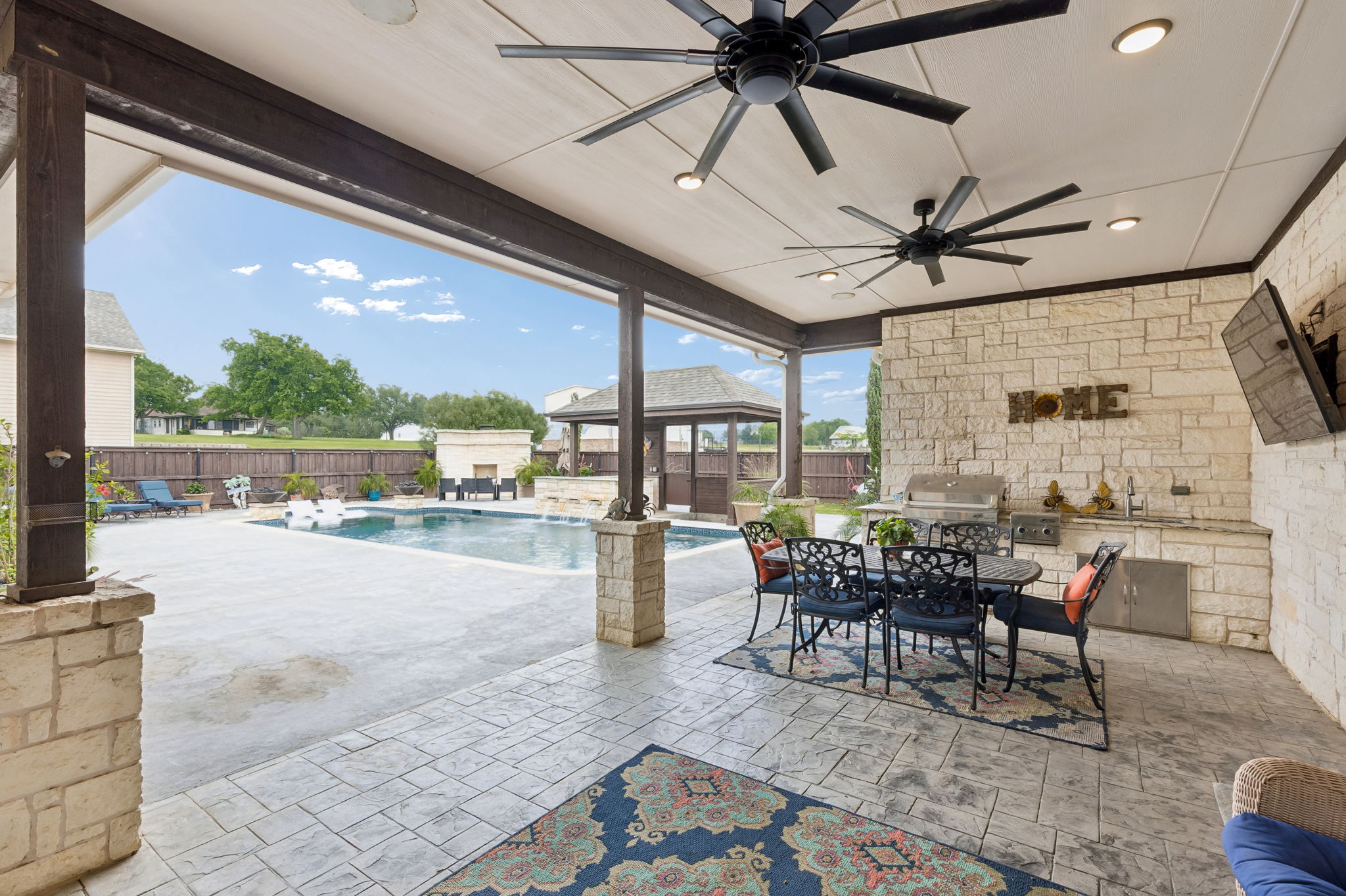 Outdoor kitchen, television, ceiling fans and surround sound to create a comfortable mood for your enjoyment.