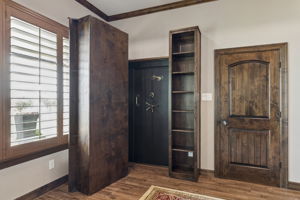 Safe room hidden behind the bookshelf in the game room.