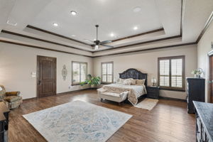 Door leading to side porch. Tray ceiling with crown molding and a ceiling fan .