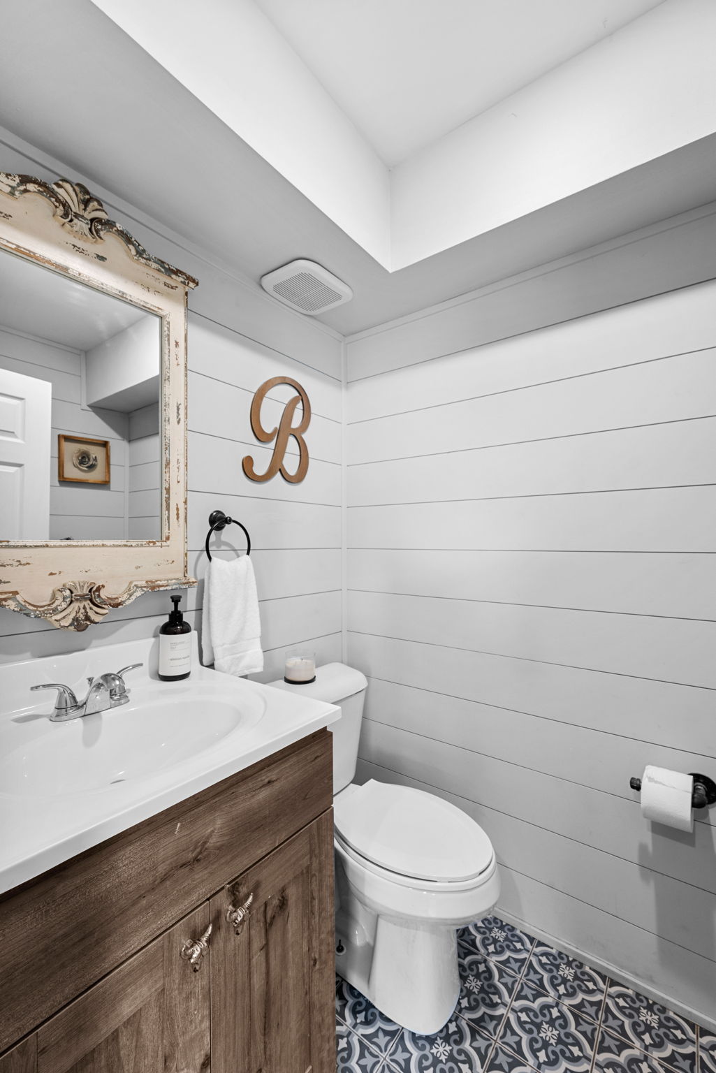 Main floor half bath and one of THREE bathrooms on the main level of this home. Don't let the photo fool you. Behind the door is a large decorative vanity!