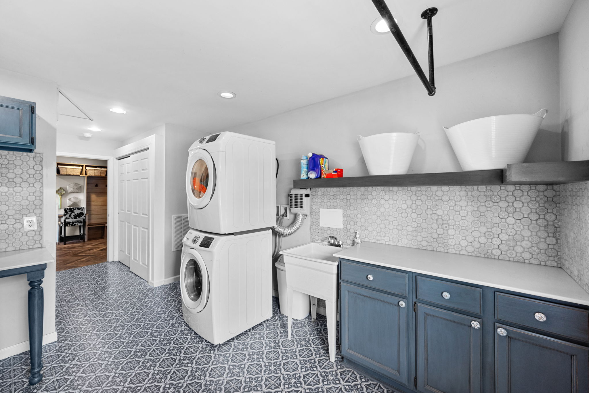 Heaven called and wants its laundry room back! This room is not only stylishly appointed but insanely practical with room to add another stackable if you want it or UNSTACK the units if it is your preference.