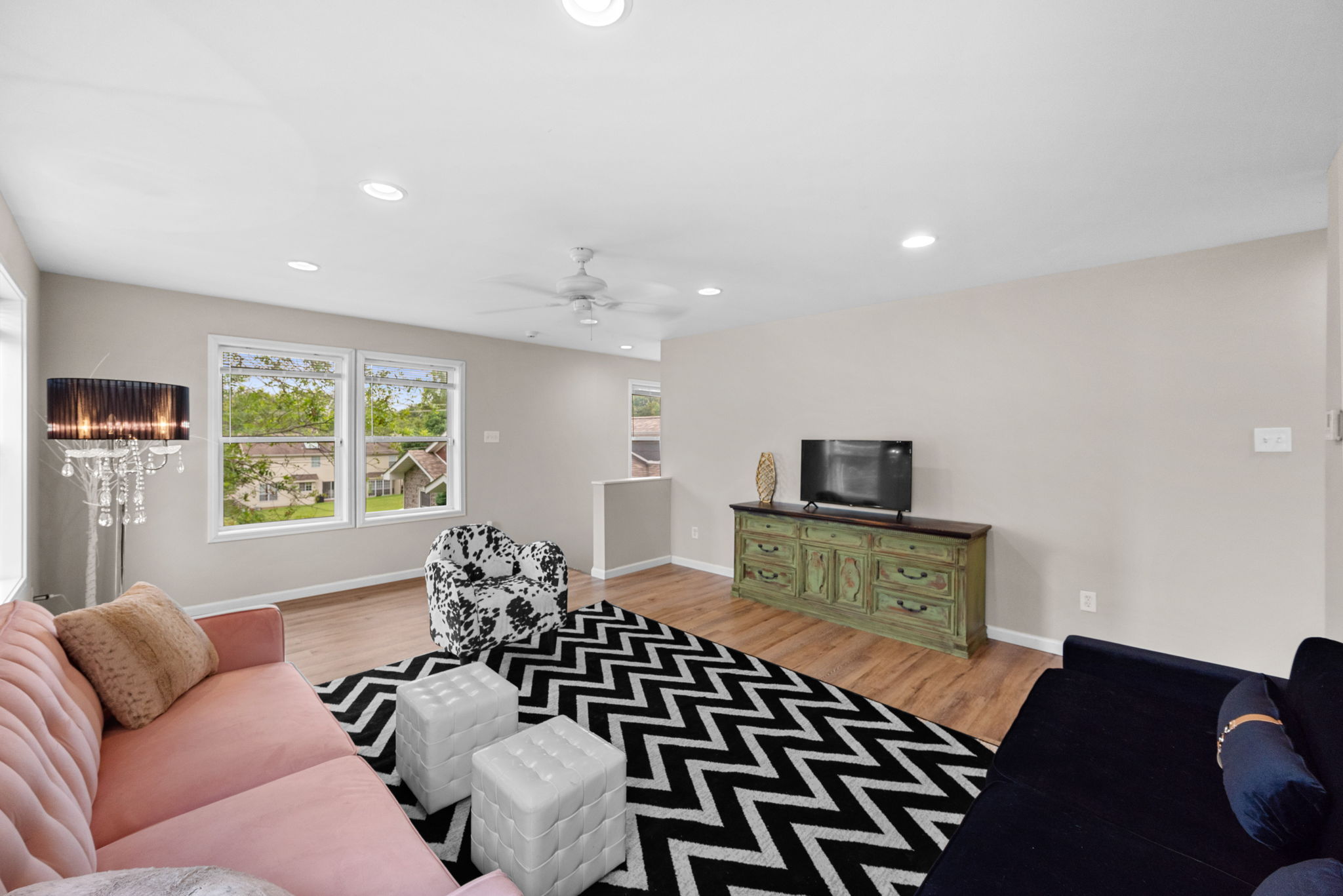 It boasts laminate floors, recessed lighting, fresh paint, and natural light galore.