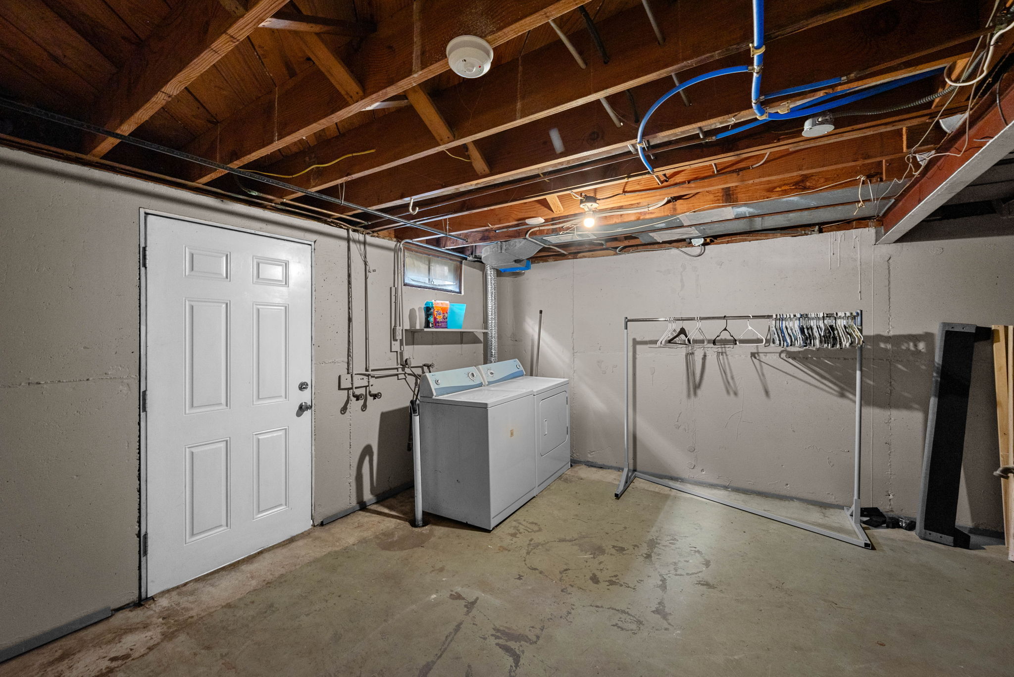 Surprise! The lower level has a a secondary laundry room.  It also boasts a sizable unfinished area with a walk-out to the backyard and oodles of storage.