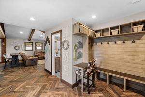 The entry foyer is ready for a busy family with a built-in mudroom and a writing desk for the mail.