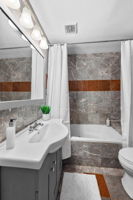 The main floor hallway full bath has a jacuzzi tub. Note- it is one of THREE bathrooms on the main level of this home.