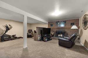 Family Room with Brick Wood-Burning Fireplace with Mantel