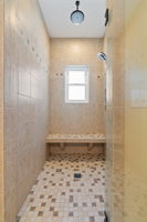 Large Primary Walk-in Tile Shower with Multiple Shower Heads