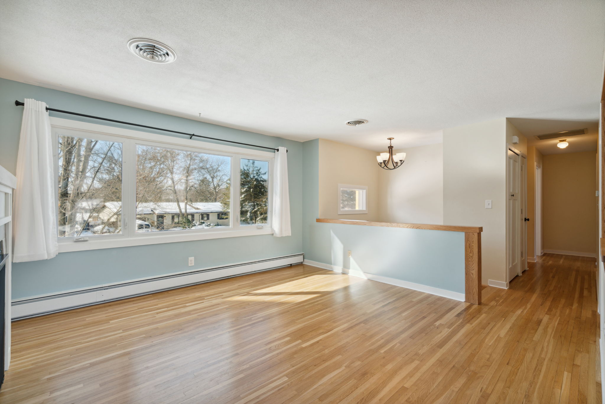Spacious living room with large windows and gas fireplace