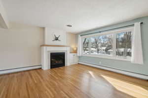 Spacious living room with large windows and gas fireplace